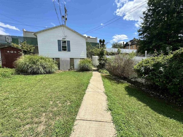 view of home's exterior with a lawn