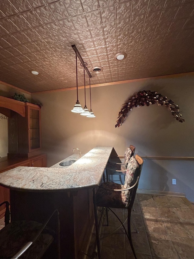 bar with sink and pendant lighting