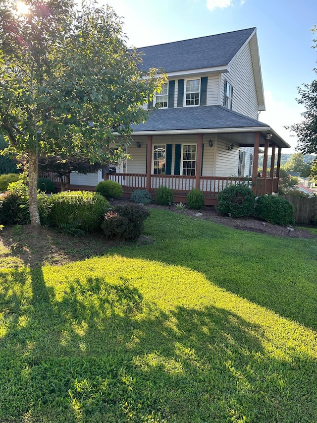 farmhouse-style home featuring a front yard and covered porch