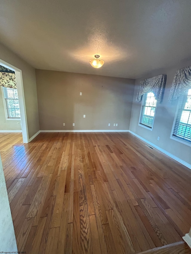 spare room featuring hardwood / wood-style flooring