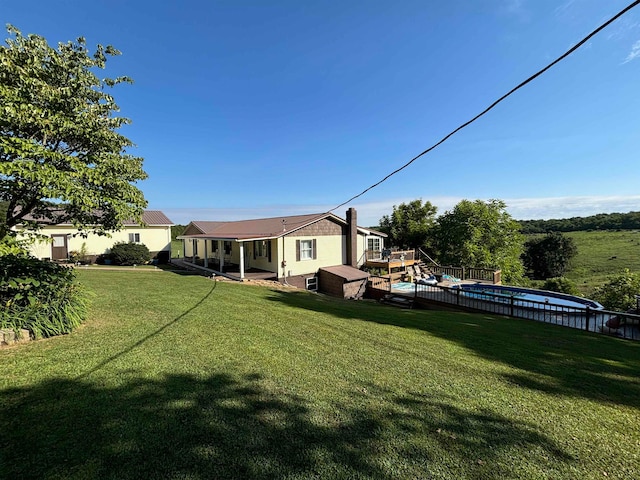 view of yard with a fenced in pool