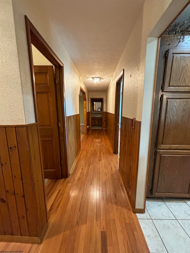 hallway with light hardwood / wood-style floors