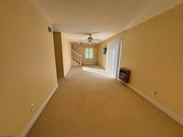 corridor featuring light carpet and a wall mounted air conditioner