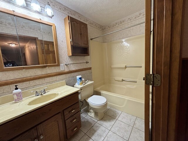 full bathroom featuring a textured ceiling, toilet, tile patterned floors,  shower combination, and vanity