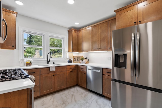 kitchen featuring sink, stainless steel appliances, light tile patterned floors, and decorative backsplash