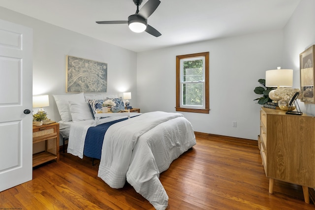 bedroom featuring dark hardwood / wood-style flooring and ceiling fan