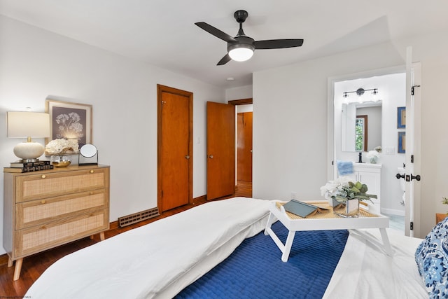 bedroom with ceiling fan, dark wood-type flooring, and ensuite bathroom