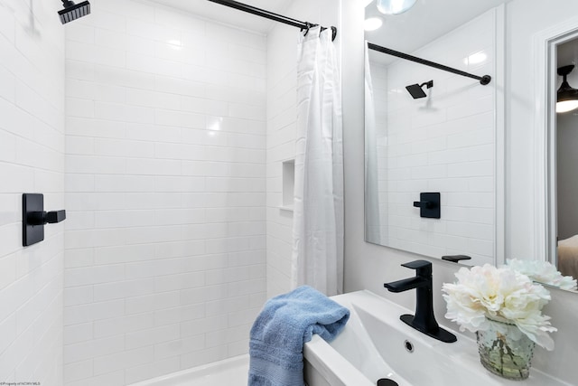 bathroom featuring sink and shower / tub combo with curtain