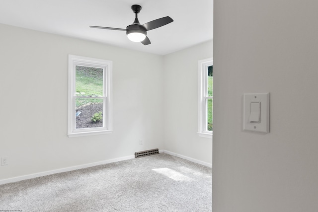 carpeted spare room with ceiling fan and a healthy amount of sunlight