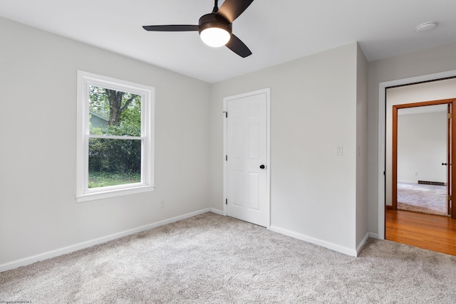 unfurnished bedroom featuring carpet flooring and multiple windows