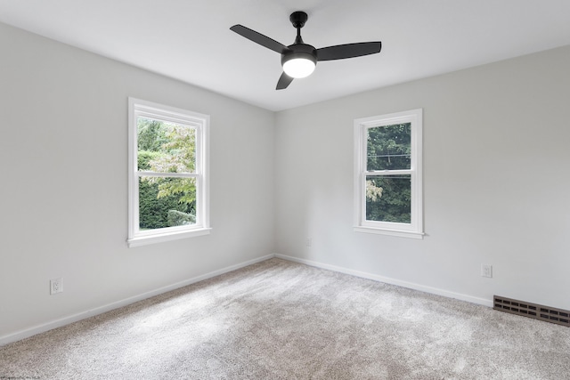 carpeted empty room featuring ceiling fan