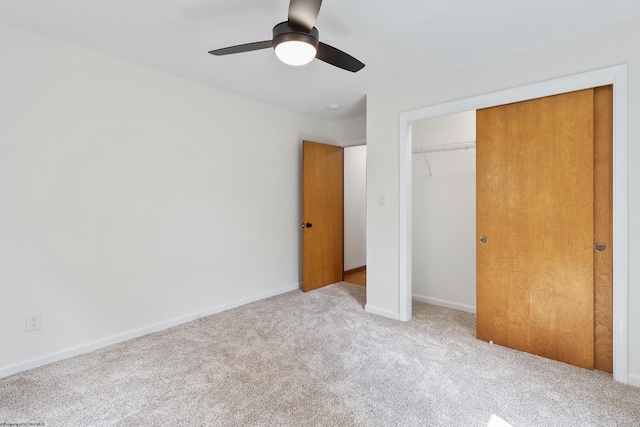 unfurnished bedroom with light colored carpet, a closet, and ceiling fan