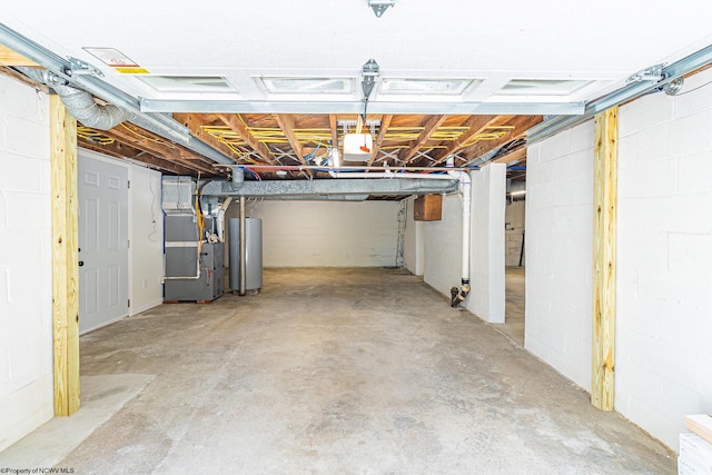 basement featuring water heater and heating unit