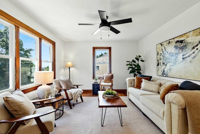 living room with light wood-type flooring and ceiling fan