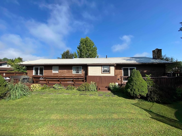 back of house with a lawn and a wooden deck