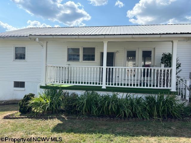 rear view of property with a porch