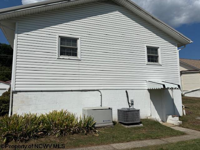 view of side of property with central AC