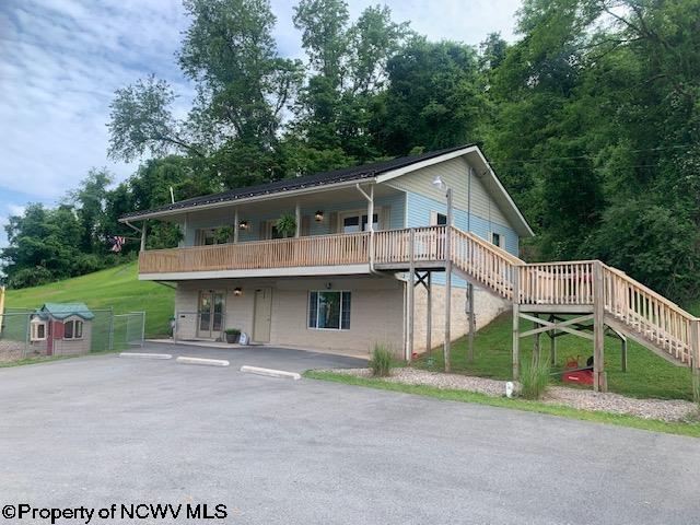 view of property featuring a deck and a front yard