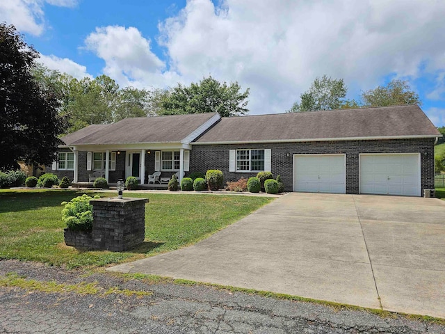 ranch-style home with a garage and a front lawn