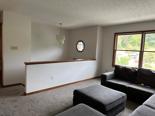 carpeted living room with a textured ceiling and an inviting chandelier