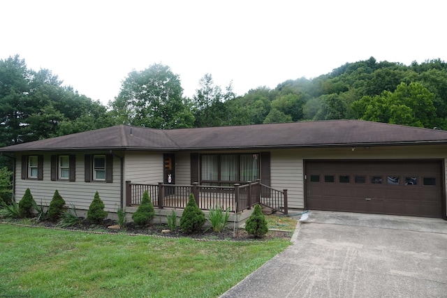 single story home with a garage, aphalt driveway, and a front yard