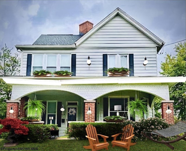 back of property with a porch