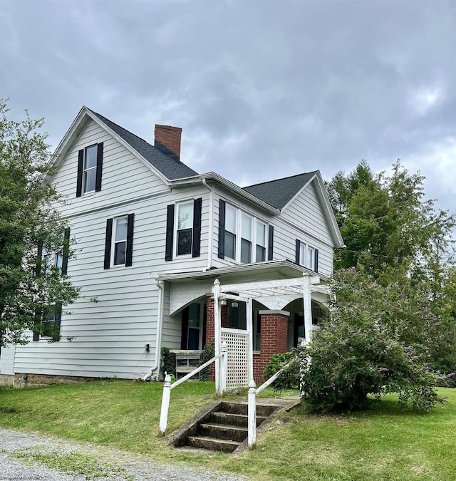 view of front facade with a front lawn and a porch