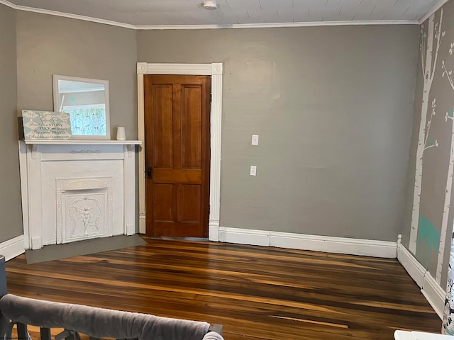 empty room with ornamental molding and dark wood-type flooring