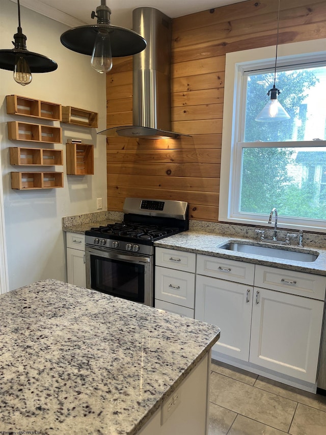 kitchen with white cabinets, sink, wall chimney exhaust hood, and stainless steel range with gas cooktop