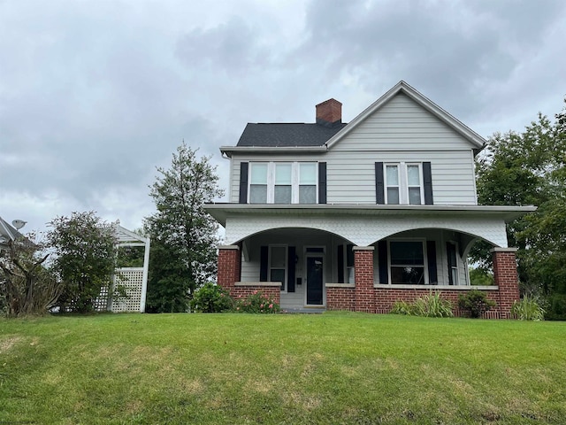 view of front of house with covered porch and a front lawn