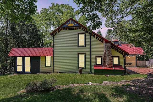 view of front facade with a patio and a lawn