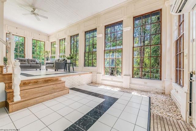 unfurnished sunroom with a wealth of natural light, ceiling fan, and a wall mounted air conditioner