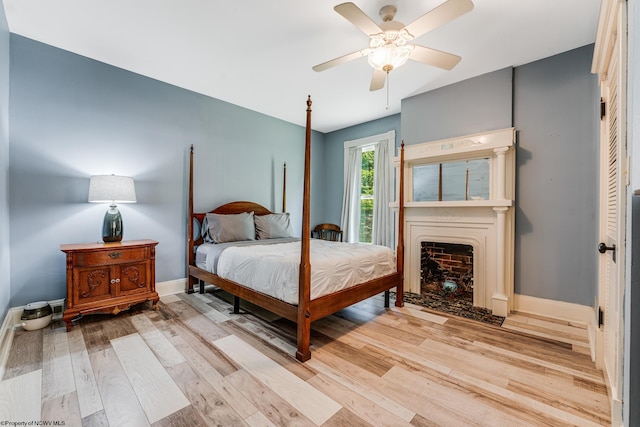 bedroom with ceiling fan and light hardwood / wood-style floors