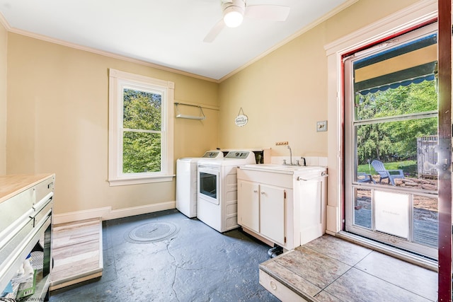 laundry room featuring ornamental molding, sink, cabinets, washer and dryer, and ceiling fan