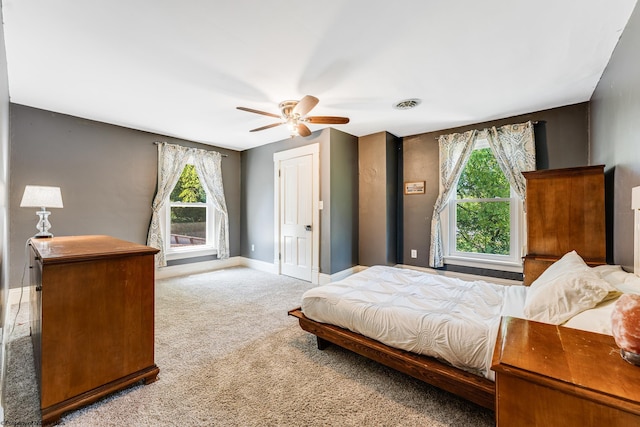 bedroom with ceiling fan and light carpet