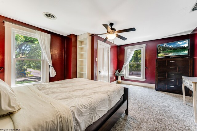 bedroom featuring multiple windows, carpet flooring, and ceiling fan