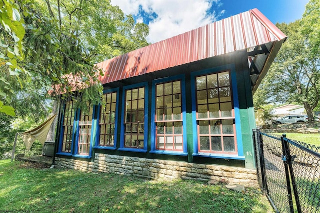 view of side of home featuring a yard