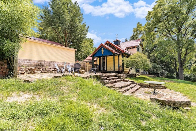 rear view of property with a patio area and a yard