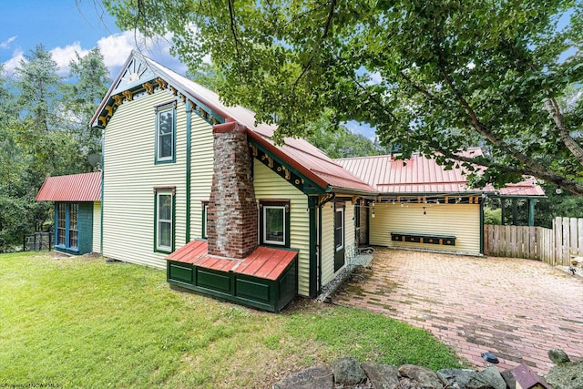 rear view of house featuring a lawn