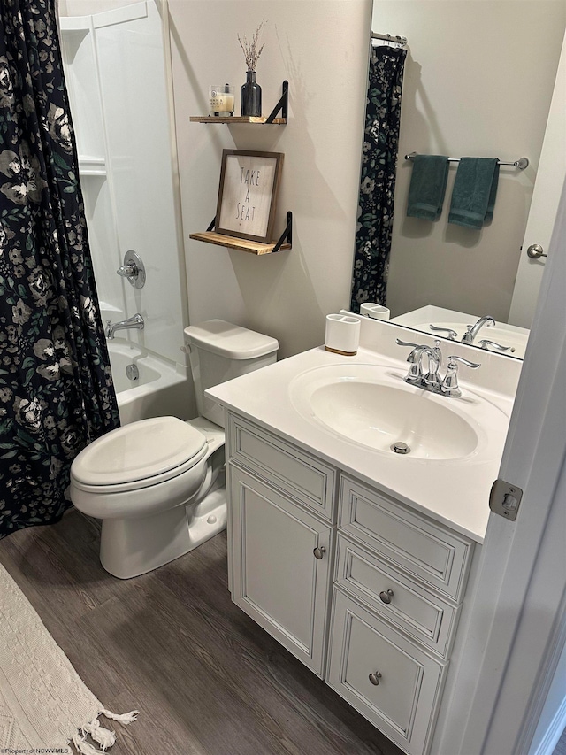 full bathroom featuring hardwood / wood-style floors, vanity, shower / bath combo, and toilet