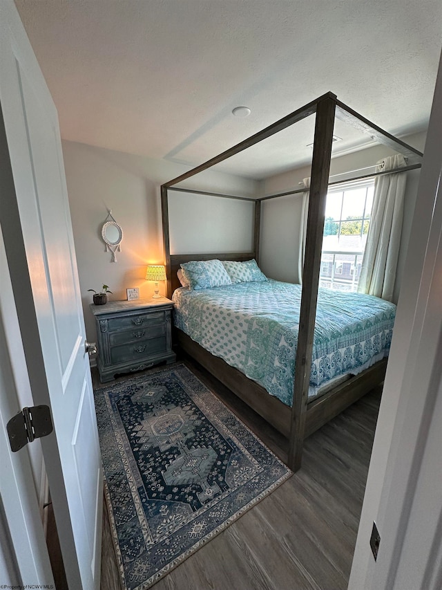 bedroom featuring dark hardwood / wood-style flooring