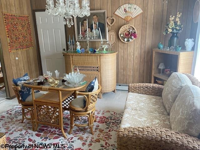 dining room with wooden walls, carpet floors, and an inviting chandelier