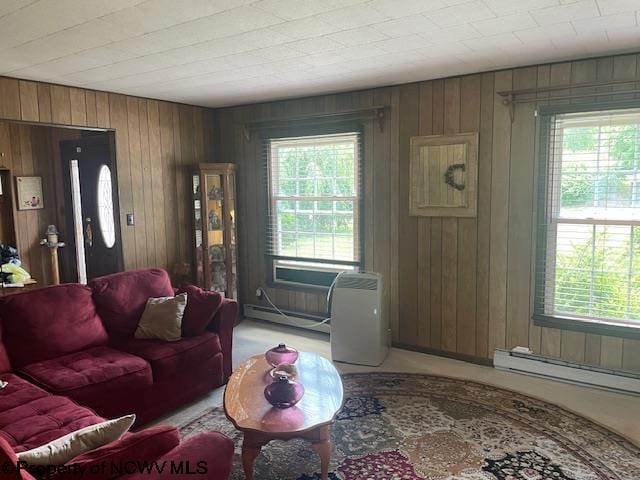 living room featuring baseboard heating and wood walls