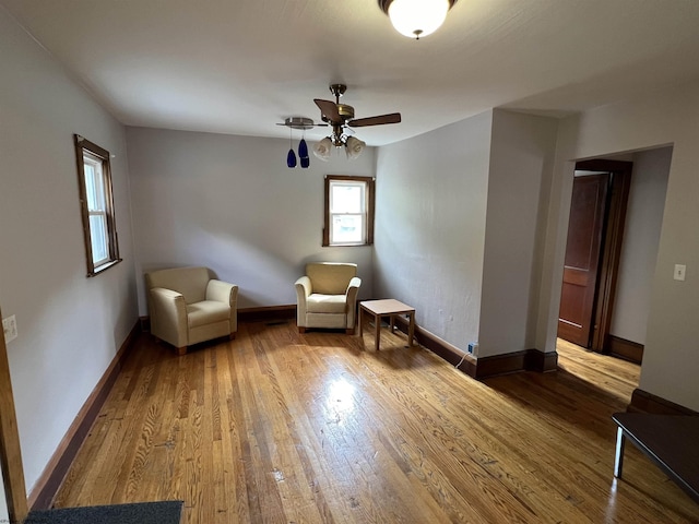 unfurnished room featuring baseboards, ceiling fan, and wood finished floors