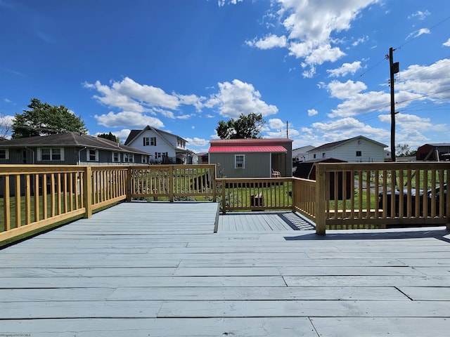 wooden terrace with an outbuilding and a residential view
