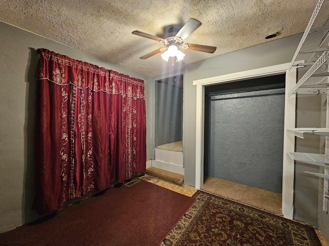bathroom with a textured ceiling and ceiling fan