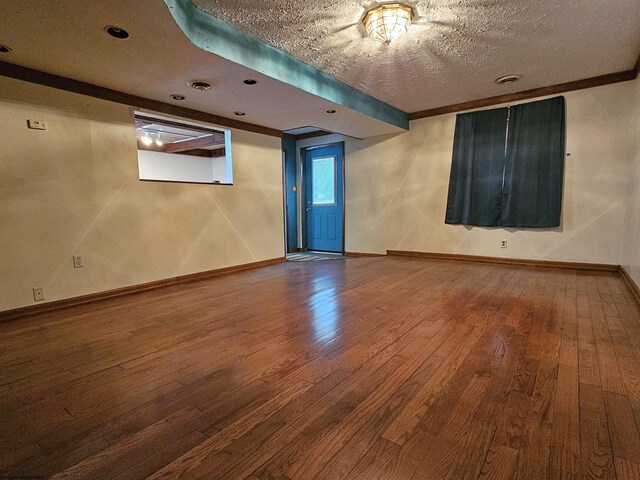 unfurnished room featuring a textured ceiling and hardwood / wood-style floors