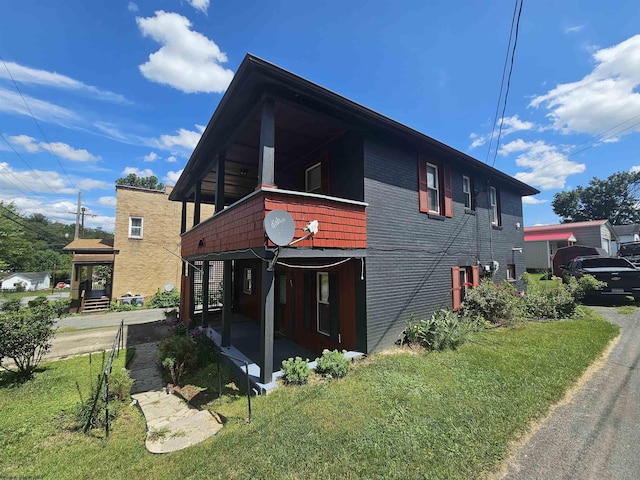 view of home's exterior featuring a yard and brick siding