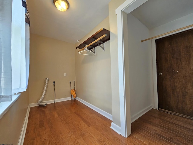 washroom with laundry area, baseboards, washer hookup, and wood finished floors