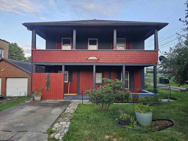 view of side of property with a yard and a balcony